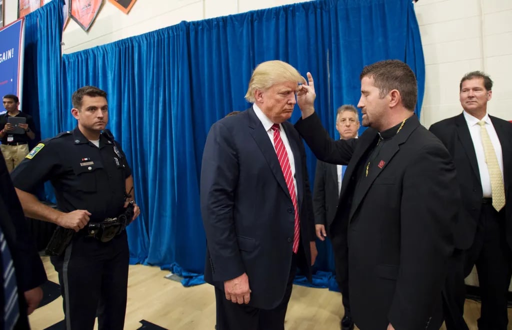 Fr. Emmanuel Lemelson blessing Donald Trump at a campaign rally in Keene, New Hampshire
