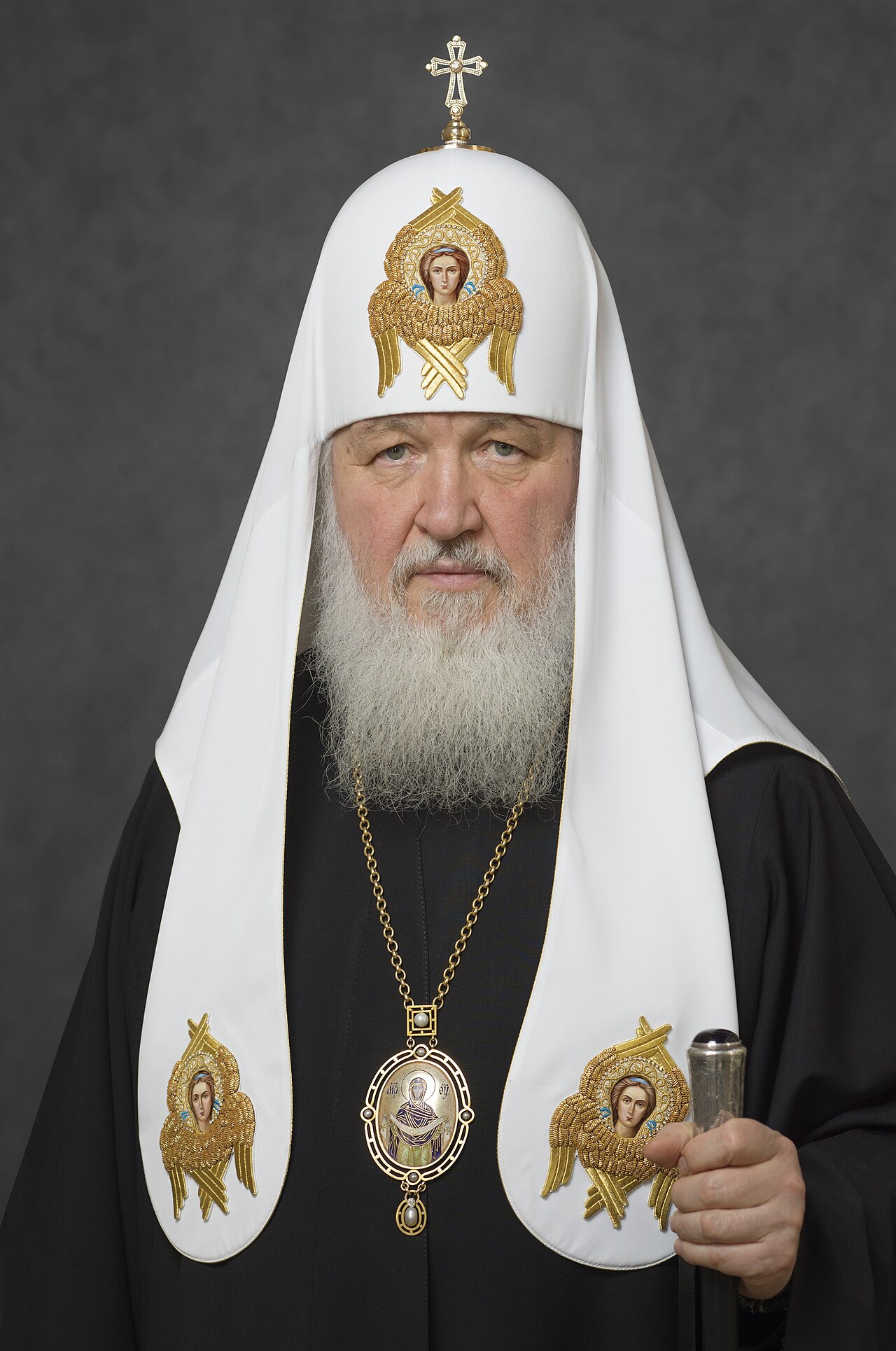 Official portrait of Patriarch Kirill (Gundayev) I of Moscow and All Russia in full patriarchal vestments, wearing the white klobuk with seraphim icons and holding a pastoral staff