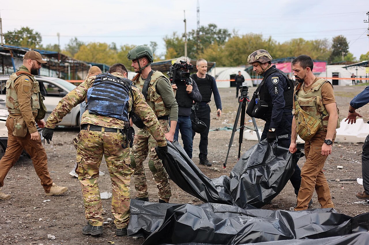 Destroyed civilian cars and body bags at the Zaporizhzhia convoy attack scene