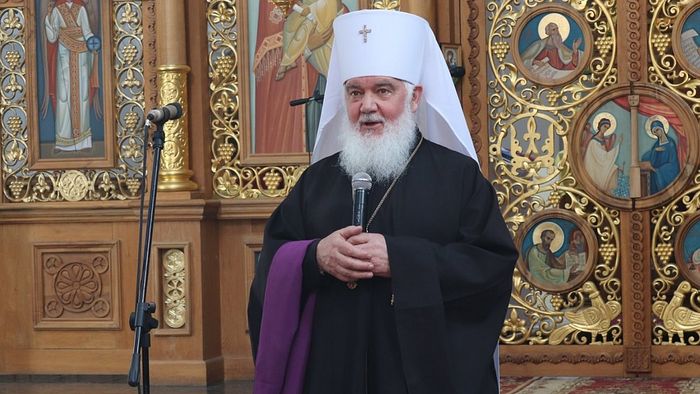 Makary Maletich speaking in front of an iconostasis, wearing black monastic vestments with a white mitre
