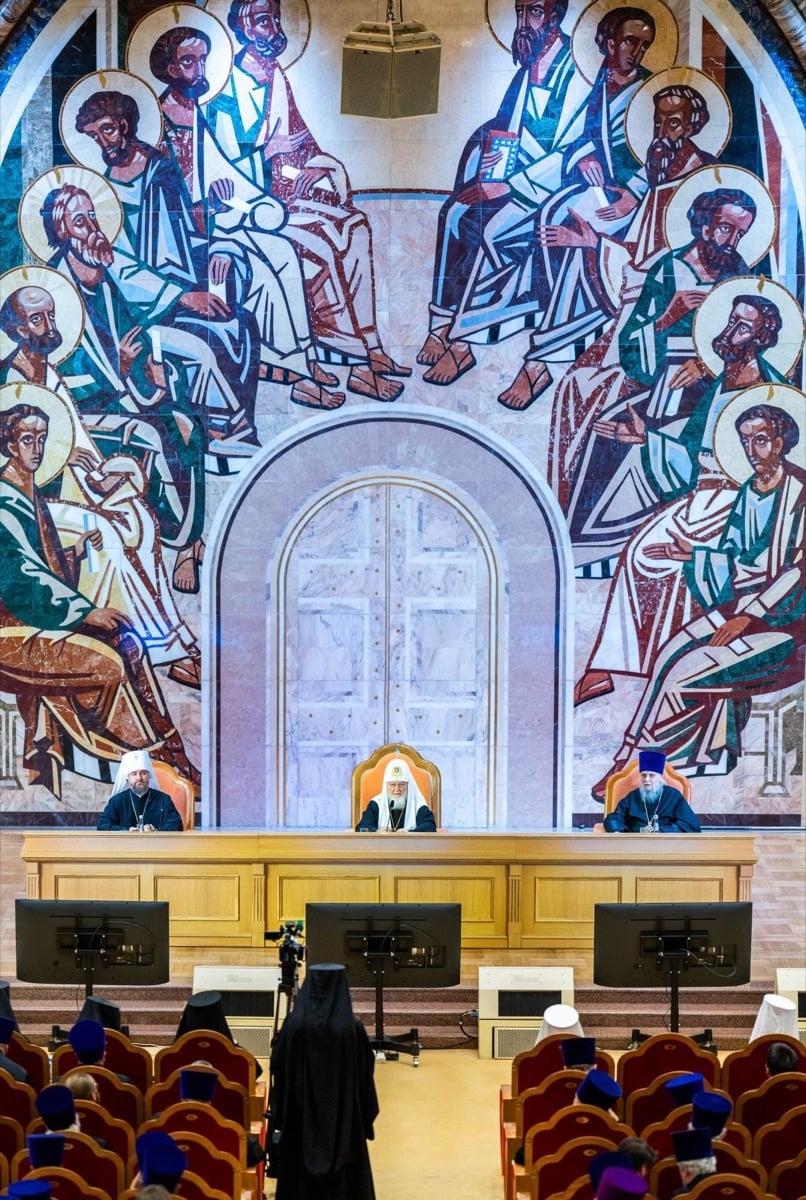 Patriarch Kirill seated at the presidium beneath a towering mosaic of the Apostles at the Cathedral of Christ the Saviour