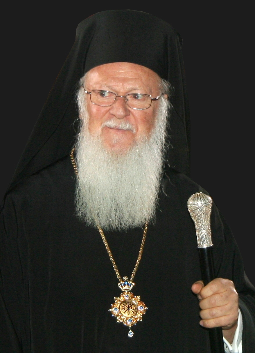 Portrait of Ecumenical Patriarch Bartholomew I of Constantinople in black patriarchal vestments, wearing glasses and holding a pastoral staff